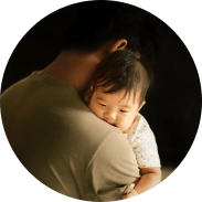A father is holding a baby