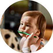 A mother is spoon-feeding a child